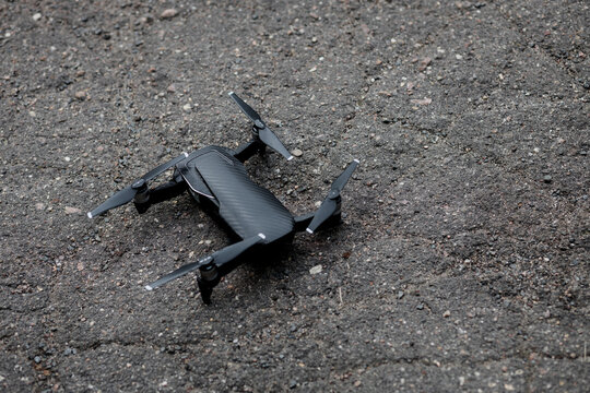 black drone on asphalt.
