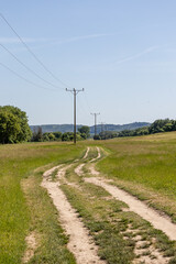 Country landscape: power line along a dirt road