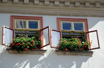 Fototapeta na wymiar open windows with flowers at Liberec old town