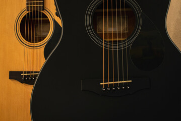 Two acoustic guitars in black and natural color.