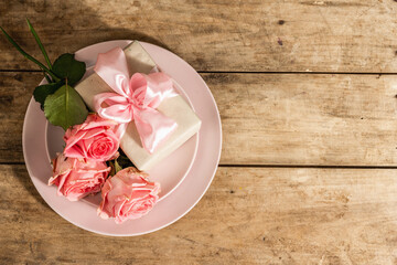 Fototapeta na wymiar Romantic dinner table on rustic background. Love cutlery for Valentine's or Mother's day, Wedding