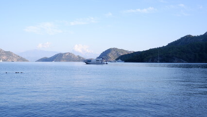 the mountains and the ship going on the sea.