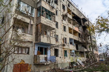 Fototapeta na wymiar War in Ukraine. 2022 Russian invasion of Ukraine. An apartment building destroyed by shelling. Destruction of infrastructure. Terror of the civilian population. War crimes