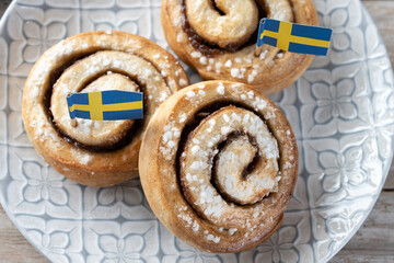 Cinnamon rolls buns on wooden table. Kanelbulle Swedish dessert