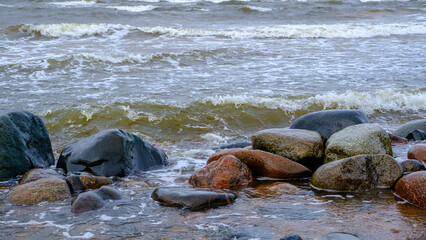 Baltic Sea, rocks at sunset. small waves after a night storm