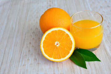 orange juice in drinking glass decorated with half of orange fruit, close-up