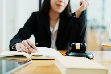 Portrait of a beautiful Asian lawyer studying a lawsuit for a client before going to court