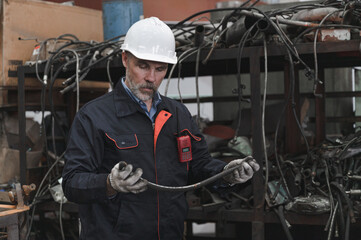 Caucasian engineer holding spares at factory spares
