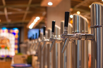 Line of beer dispensers in a bar