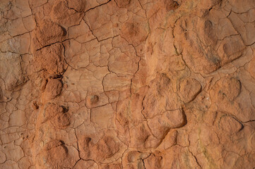 Fototapeta na wymiar Cracked red clay. Hot climate in the desert.