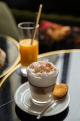 cup of coffee with cinnamon and orange