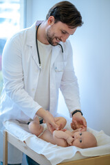 Surgeon checking babys limbs and moving them