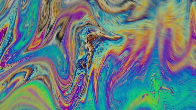Fluid soap bubble psychedelic colorful abstract art. Surreal patterns with rainbows and waves of color in motion.
