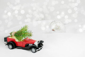 A Christmas card or poster. Red car, snow, gifts, glitter. Blurred fabulous bokeh background