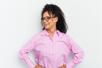Young african american woman isolated laughs happily and has fun keeping hands on stomach.