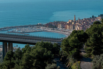 Beautiful cityscape of the Spanish harbor city by blue water under blue sky
