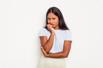 Fototapeta premium Young Indian woman isolated on white background biting fingernails, nervous and very anxious.