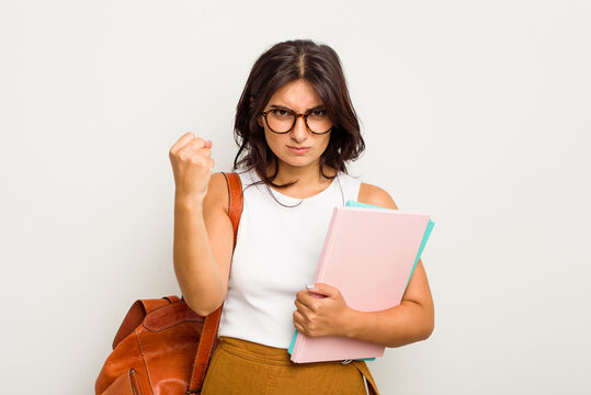 Young student Indian woman isolated on white background showing fist to camera, aggressive facial expression.