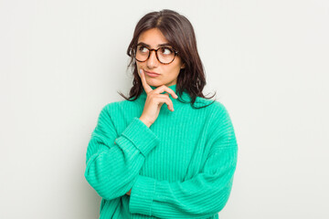 Young Indian woman isolated on white background contemplating, planning a strategy, thinking about the way of a business.