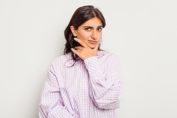 Fototapeta premium Young Indian woman isolated on white background contemplating, planning a strategy, thinking about the way of a business.
