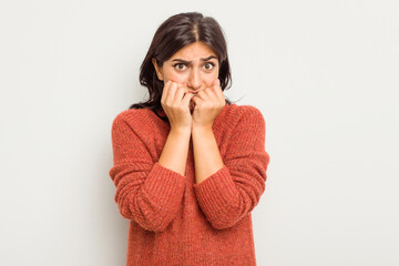 Young Indian woman isolated on white background biting fingernails, nervous and very anxious.