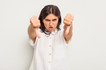 Young Indian woman isolated on white background showing thumb down and expressing dislike.