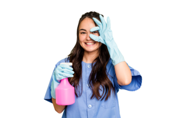 Young cleaner caucasian woman isolated on green chroma background excited keeping ok gesture on eye.