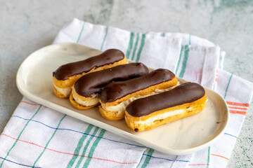 Chocolate eclair cake on gray background. Bakery products. close up
