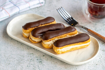 Chocolate eclair cake on gray background. Bakery products. close up