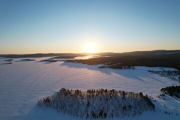 Sunrise over the forest near Inari Lake Lapland, Finland