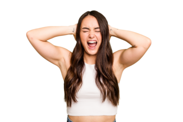 Young caucasian woman isolated on green chroma background covering ears with hands trying not to hear too loud sound.