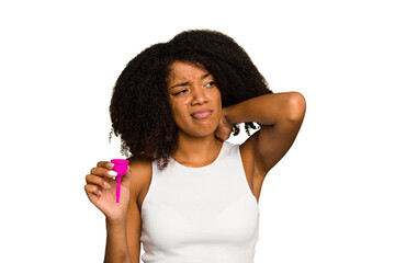 Fototapeta na wymiar Young African American woman holding a menstrual cup isolated touching back of head, thinking and making a choice.
