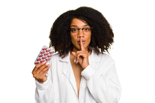 Young pharmacist African American woman holding a tablet of pills isolated keeping a secret or asking for silence.