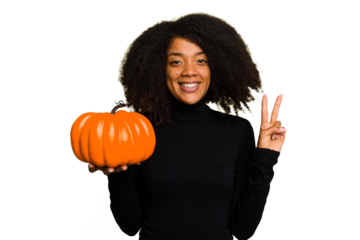 Young African American woman holding a pumpkin for halloween day isolated showing number two with fingers.
