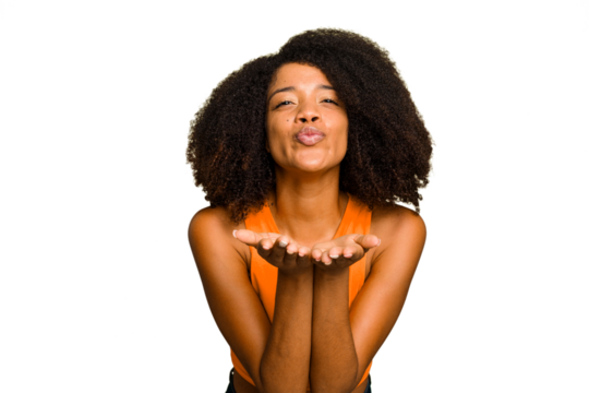 Young African American woman isolated folding lips and holding palms to send air kiss.