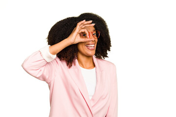 Young African American woman isolated excited keeping ok gesture on eye.