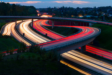 German Motorway junction in Bochum. Streets and bridges at dusk with colorful light traces of...