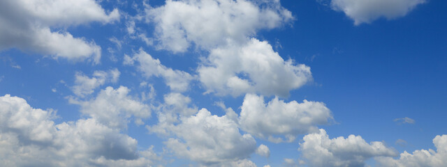 Naklejka na ściany i meble Beautiful blue sky with white fluffy clouds. Banner design