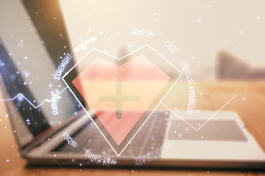 Double exposure of creative abstract heart rate hologram on laptop background. Healthcare technolody concept