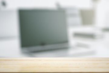 Empty office wooden table with empty space on modern workplace with computer background, closeup,...