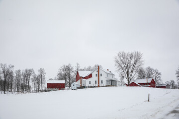 Amish farm on a snowy hill in the winter in Holmes County, Ohio