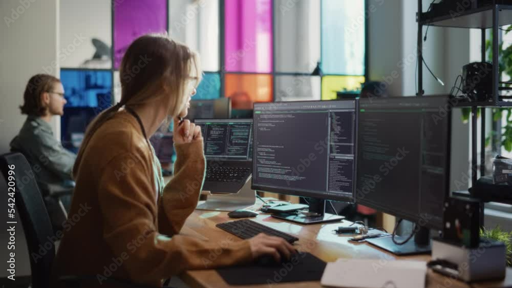 Poster Caucasian Woman Writes Lines of Code on Desktop PC with Multiple Displays and a Laptop in Stylish Office. Professional Female Data Scientist Using Software To Analyze Information from Internet.