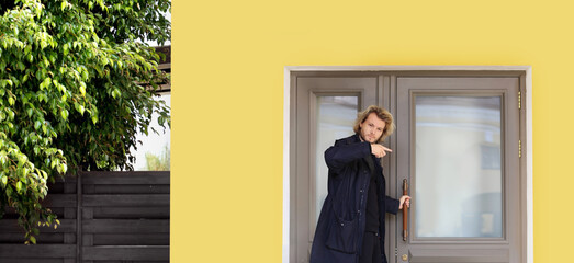 young man opening the door of his house.Inviting the guests