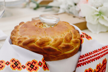 Russian traditional cuisine: loaf bread and salt served on a towel with Russian folk ornament