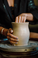 Master class on modeling of clay on a potter's wheel In the pottery workshop