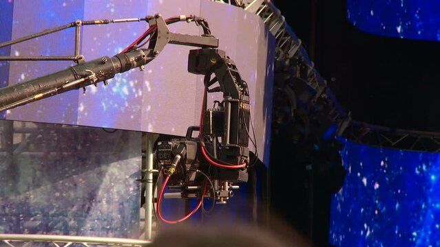 a television video camera on the operator's crane at work at a concert