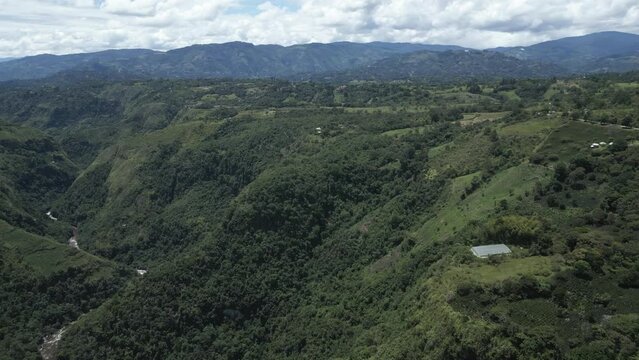 aerial view of natural green forest in Colombia with rio Magdalena river passing through wild vegetation andes mountains in South America