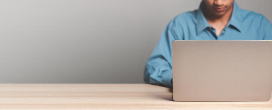 Businessman using laptop computer writing email or message, chatting, shopping. Working online on computer. Copy space.