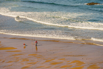 Angler with fishing rod on sea shore