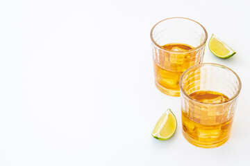 Glass of strong alcoholic drink whiskey with ice. Alcohol background